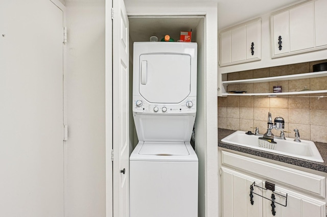 2400 Presidential Way Unit 302, West Palm Beach, FL 33401 - laundry room with stacked washing machine and dryer and a sink