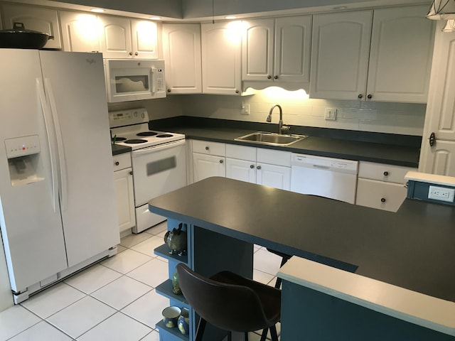 1800 SE Saint Lucie Blvd Unit 5203, Stuart, FL 34996 - kitchen featuring white appliances, a sink, light tile patterned floors, dark countertops, and white cabinets
