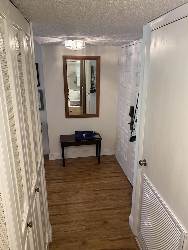 1800 SE Saint Lucie Blvd Unit 5203, Stuart, FL 34996 - hall featuring wood finished floors, a textured ceiling, and baseboards