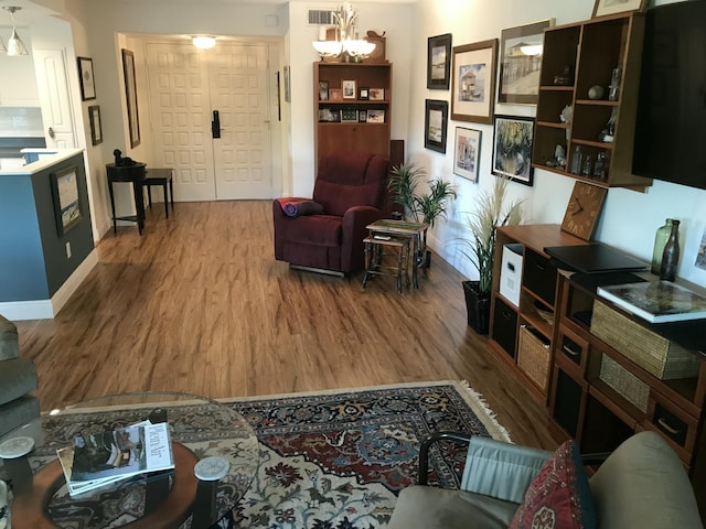 1800 SE Saint Lucie Blvd Unit 5203, Stuart, FL 34996 - living area featuring wood finished floors, a chandelier, and baseboards