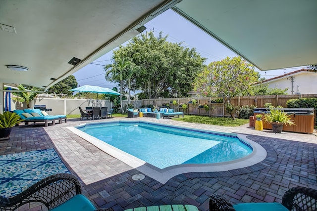 view of swimming pool featuring a hot tub, a fenced backyard, an outdoor hangout area, a patio, and outdoor dining space