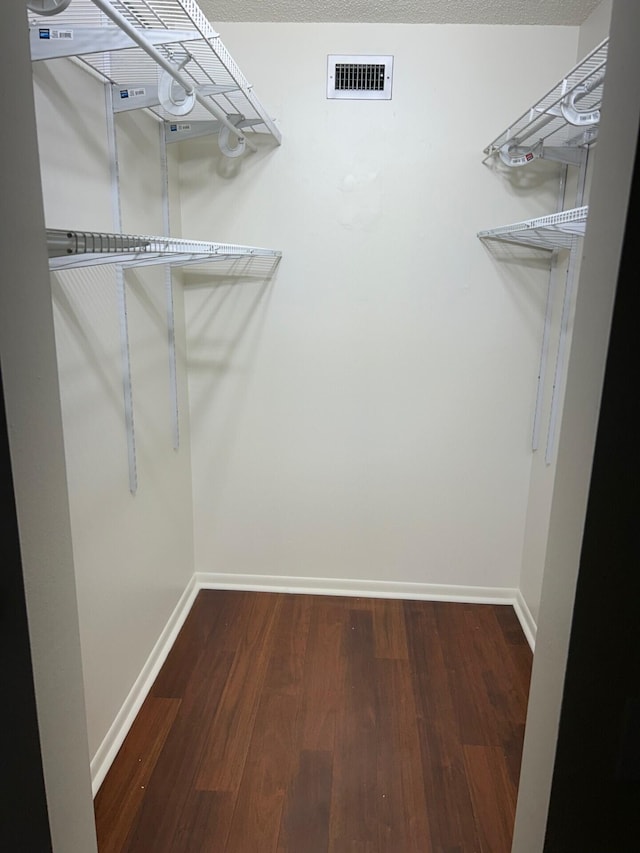spacious closet with visible vents and wood finished floors