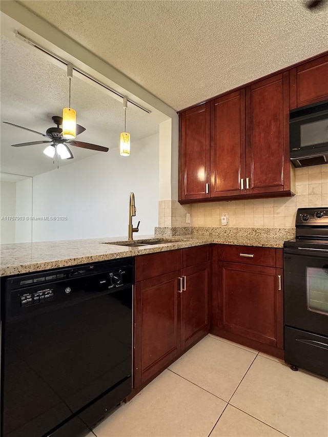 kitchen with tasteful backsplash, light stone counters, a sink, and black appliances