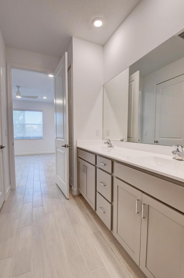 6975 Peters Ln, Delray Beach, FL 33446 - bathroom with double vanity, baseboards, ceiling fan, and a sink