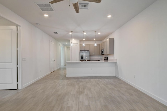 6975 Peters Ln, Delray Beach, FL 33446 - kitchen featuring visible vents, light wood finished floors, stainless steel appliances, light countertops, and ceiling fan