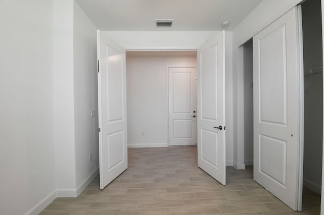 6975 Peters Ln, Delray Beach, FL 33446 - corridor featuring visible vents, baseboards, and wood tiled floor