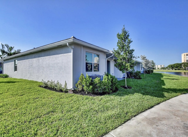 6975 Peters Ln, Delray Beach, FL 33446 - view of side of property featuring a yard, cooling unit, a water view, and stucco siding