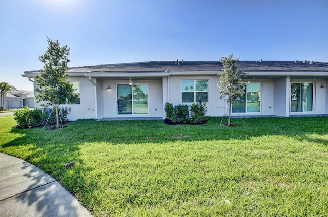 6975 Peters Ln, Delray Beach, FL 33446 - rear view of house with stucco siding, a ceiling fan, and a yard