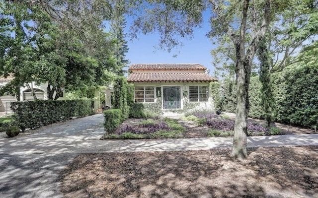 view of front of house with stucco siding and a tiled roof