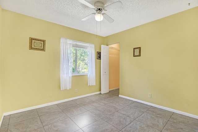 436 Pine Glen Ln Unit C-2, Greenacres, FL 33463 - tiled empty room featuring baseboards, a textured ceiling, and ceiling fan