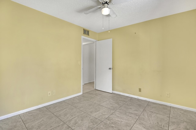 436 Pine Glen Ln Unit C-2, Greenacres, FL 33463 - tiled empty room featuring baseboards, visible vents, a textured ceiling, and ceiling fan