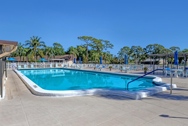 436 Pine Glen Ln Unit C-2, Greenacres, FL 33463 - community pool featuring a patio area and fence