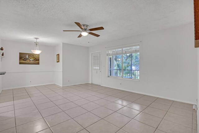 436 Pine Glen Ln Unit C-2, Greenacres, FL 33463 - spare room with light tile patterned flooring, a ceiling fan, baseboards, and a textured ceiling