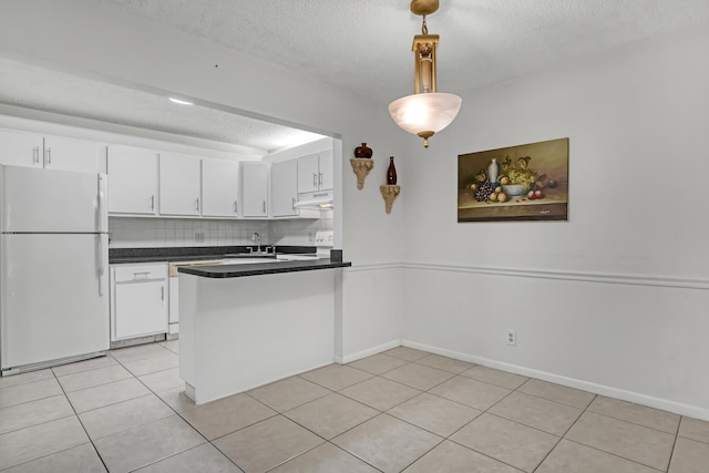 436 Pine Glen Ln Unit C-2, Greenacres, FL 33463 - kitchen featuring dark countertops, white cabinets, and freestanding refrigerator