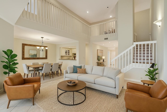 living room featuring baseboards, an inviting chandelier, light tile patterned flooring, a towering ceiling, and stairway