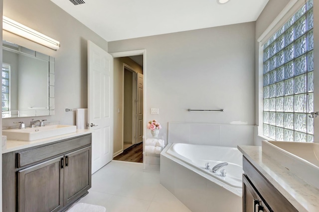 2737 Clipper Cir, West Palm Beach, FL 33411 - bathroom featuring plenty of natural light, two vanities, and a bath