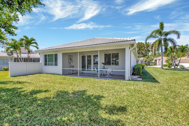 2737 Clipper Cir, West Palm Beach, FL 33411 - back of house with a ceiling fan, a tiled roof, a yard, and stucco siding