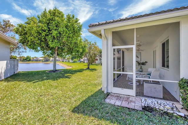 2737 Clipper Cir, West Palm Beach, FL 33411 - view of grassy yard with a sunroom, a water view, and a ceiling fan