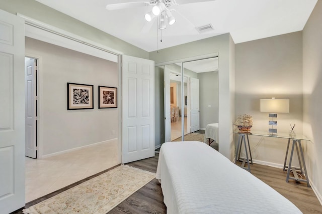 2737 Clipper Cir, West Palm Beach, FL 33411 - bedroom with baseboards, wood finished floors, a closet, and a ceiling fan