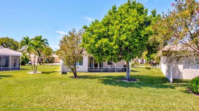 2737 Clipper Cir, West Palm Beach, FL 33411 - view of green lawn with a sunroom