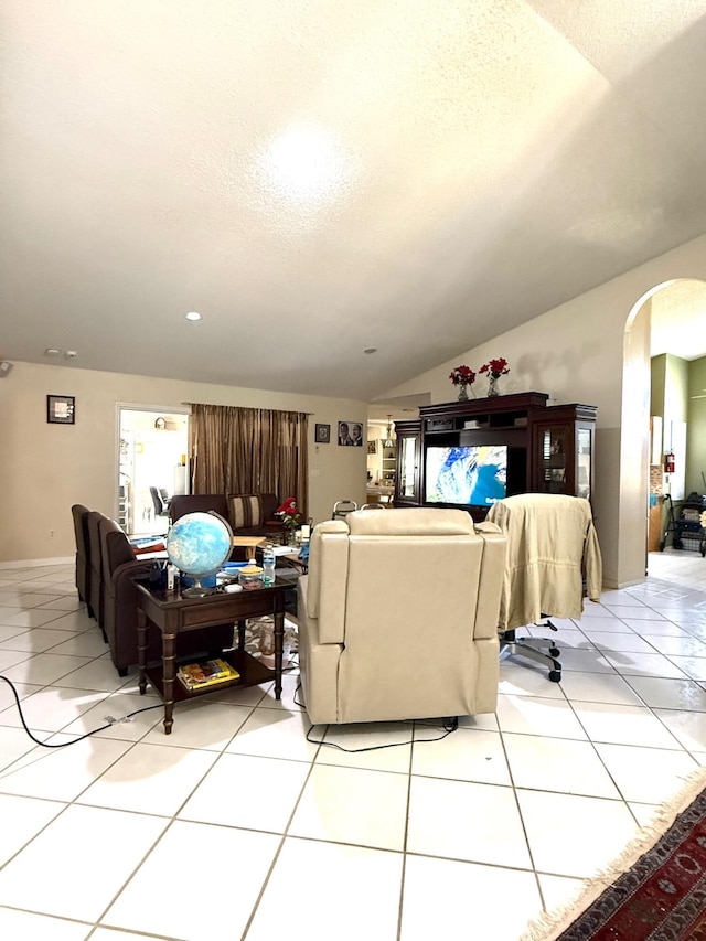 434 SE Doat St, Port Saint Lucie, FL 34983 - living area featuring light tile patterned flooring, lofted ceiling, arched walkways, and a textured ceiling