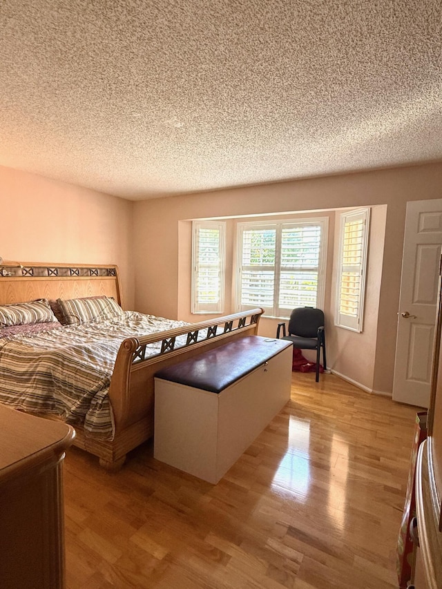 434 SE Doat St, Port Saint Lucie, FL 34983 - bedroom featuring baseboards, light wood-style flooring, and a textured ceiling