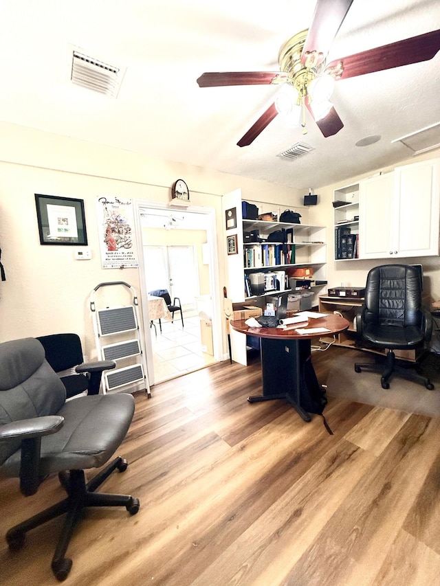 434 SE Doat St, Port Saint Lucie, FL 34983 - home office featuring visible vents, light wood-style floors, and a ceiling fan