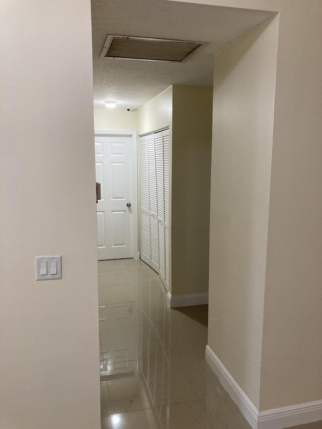 1112 Wild Cherry Ln, Wellington, FL 33414 - corridor with tile patterned flooring, attic access, and baseboards
