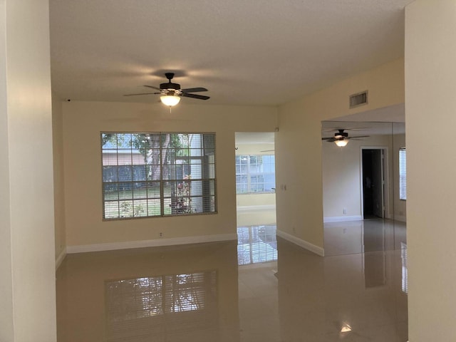 1112 Wild Cherry Ln, Wellington, FL 33414 - tiled spare room with baseboards, visible vents, a wealth of natural light, and ceiling fan