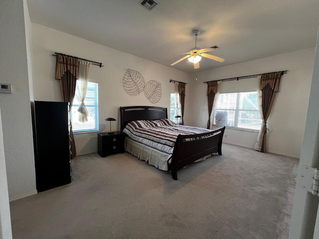 bedroom featuring light carpet and baseboards
