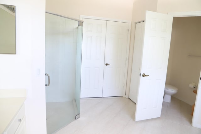 full bathroom with a stall shower, toilet, and vanity