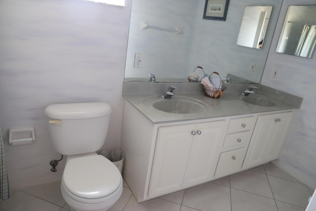 full bathroom featuring toilet, tile patterned floors, and double vanity