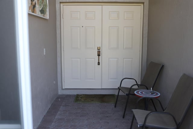 entrance to property featuring stucco siding