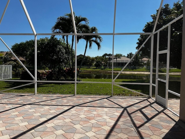 unfurnished sunroom with a water view