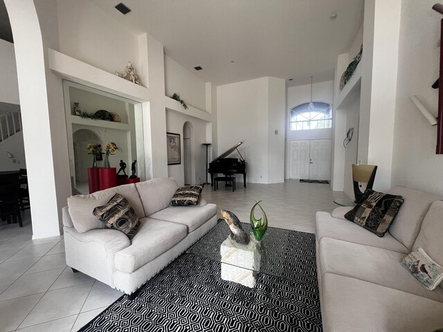 living room with light tile patterned floors and arched walkways