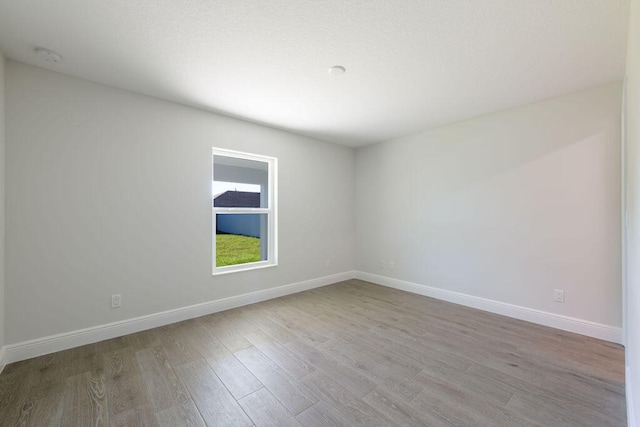 2372 SW Import Dr, Port Saint Lucie, FL 34953 - spare room featuring baseboards and wood finished floors