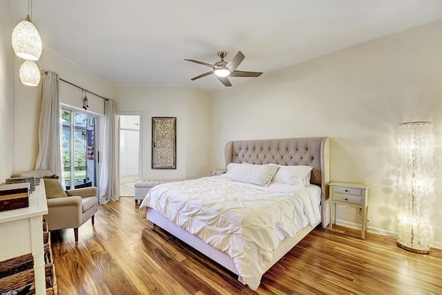 bedroom with baseboards, wood finished floors, a ceiling fan, and access to outside