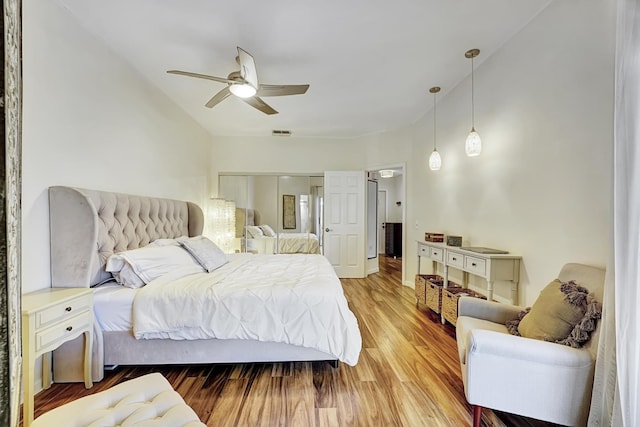bedroom with visible vents, a ceiling fan, and light wood finished floors