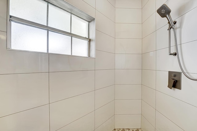 full bath with a tile shower