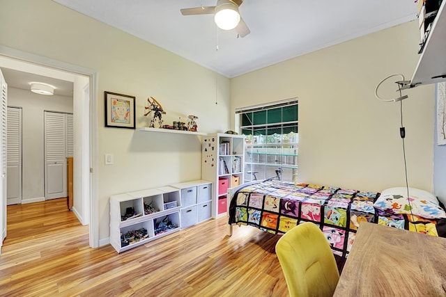 bedroom featuring baseboards, a ceiling fan, and wood finished floors