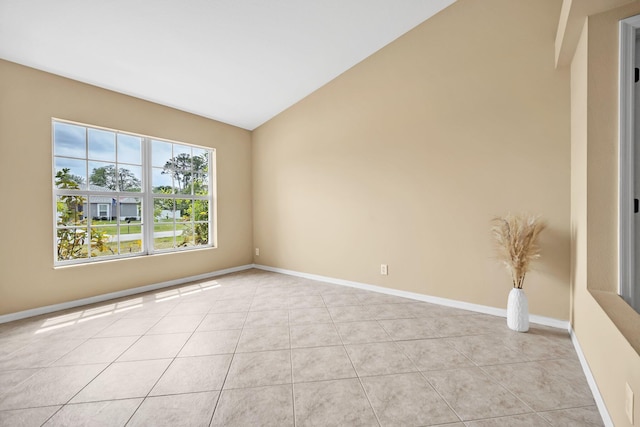 1355 SW Porter Rd, Port Saint Lucie, FL 34953 - spare room with light tile patterned flooring, baseboards, and vaulted ceiling