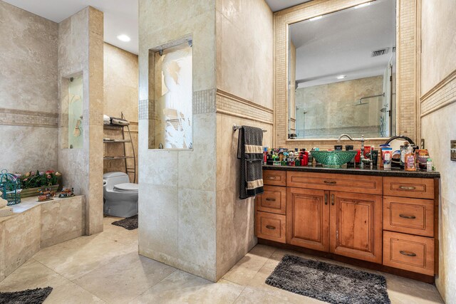 16090 Rio Del Paz, Delray Beach, FL 33446 - bathroom featuring tile walls, toilet, vanity, a tile shower, and tile patterned floors
