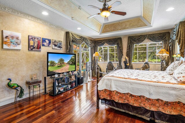 16090 Rio Del Paz, Delray Beach, FL 33446 - bedroom featuring a textured wall, hardwood / wood-style floors, a textured ceiling, a tray ceiling, and baseboards