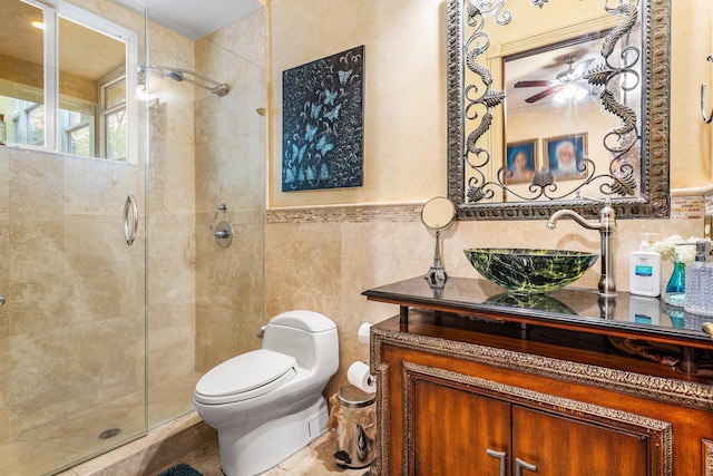 16090 Rio Del Paz, Delray Beach, FL 33446 - bathroom featuring a stall shower, toilet, vanity, tile walls, and a ceiling fan