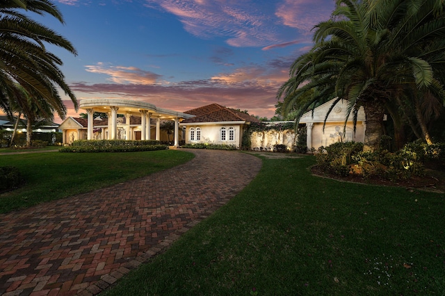 16090 Rio Del Paz, Delray Beach, FL 33446 - view of front of property featuring curved driveway, a front yard, and stucco siding