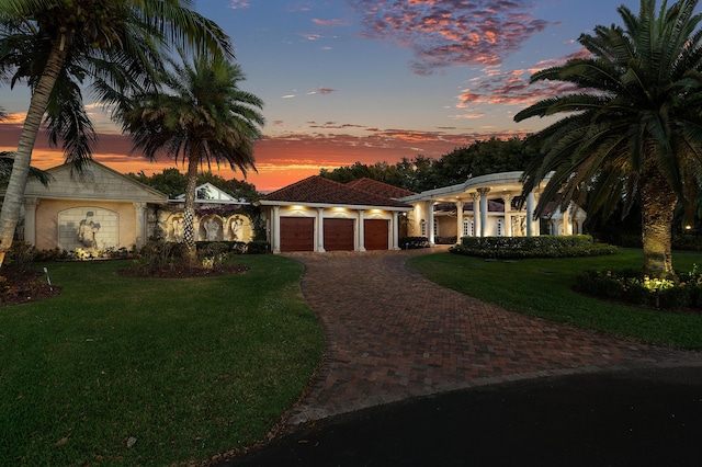 16090 Rio Del Paz, Delray Beach, FL 33446 - mediterranean / spanish house featuring a garage, decorative driveway, a front lawn, and stucco siding