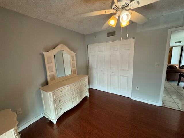 2075 SW 122nd Ave Unit 513, Miami, FL 33175 - unfurnished bedroom with visible vents, a closet, wood finished floors, and a textured ceiling