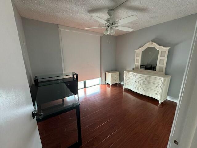 2075 SW 122nd Ave Unit 513, Miami, FL 33175 - bedroom with baseboards, a ceiling fan, wood finished floors, and a textured ceiling