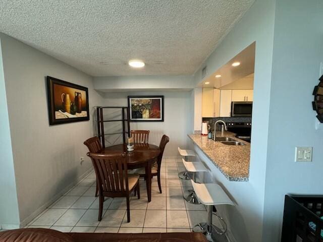 2075 SW 122nd Ave Unit 513, Miami, FL 33175 - dining area with light tile patterned flooring, baseboards, recessed lighting, and a textured ceiling