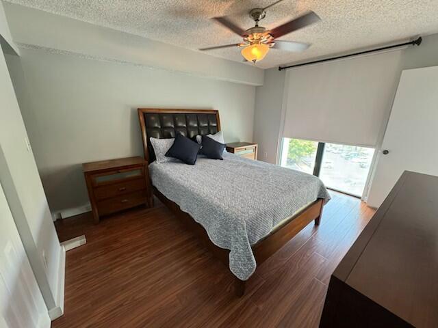 2075 SW 122nd Ave Unit 513, Miami, FL 33175 - bedroom with a ceiling fan, a textured ceiling, and wood finished floors